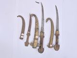 five different types of knives on display on the wall