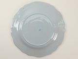 a blue plate on a white table with a white background