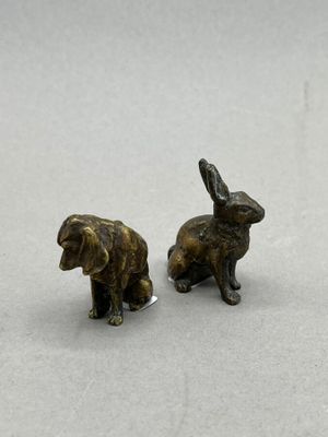 pair of bronze figurines of a rabbit and a dog