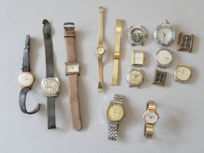 a lot of watches that are sitting on a table