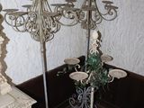 a table with three candles and a clock on it