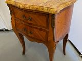 a small wooden table with a marble top on it