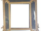 a mirror with a gold frame on a white wall