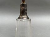 an image of a glass bottle with a metal stopper
