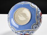 a blue and white bowl sitting on a white table