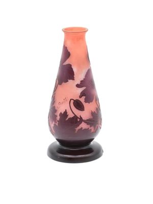 a glass vase with a bird on it on a stand