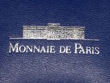 a close up of the logo on a blue leather bag
