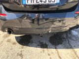 a car that has a sticker on the back of it ' s bumper