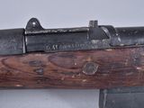 an old rifle with a wooden handle on a white surface