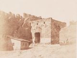 an old photo of a building in the middle of the desert