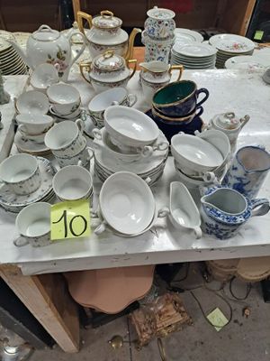 une table sur laquelle se trouvent beaucoup de plats et de tasses