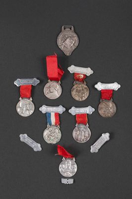 a lot of medals and medals on a black surface