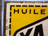 a yellow and black sign on the wall of a building