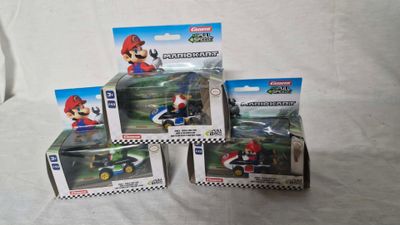 three nintendo mario kart action figures in boxes on a white surface