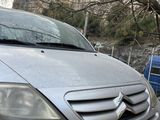 a silver car that is parked on the side of the road
