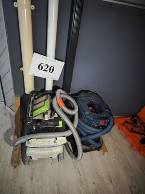 an image of a room with a vacuum and a bag on the floor