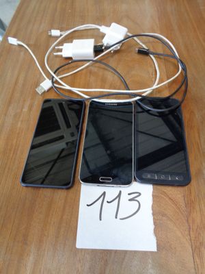 trois téléphones portables posés sur une table, avec une étiquette de prix accrochée dessus