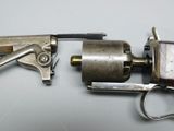 a pair of scissors that are next to a gun