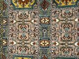 an antique persian rug with a multicolored design