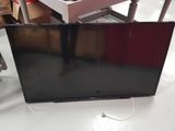 a flat screen tv sitting on a table in a room