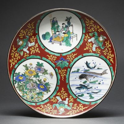 a red plate with four different designs on it