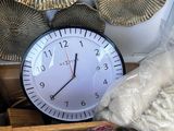 a clock that is sitting next to a box of nuts