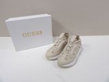 guess shoes in white with gold logo on the side