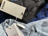 several different types of clothing on a table with tags on them