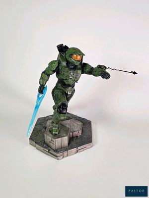 statue of a man in a green suit holding a blue sword