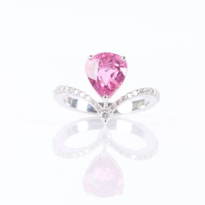 a pink tourmaline and diamond ring on a white background