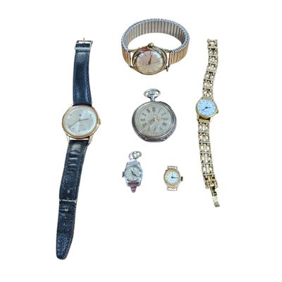several watches and bracelets are arranged on a white surface