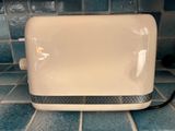 a toaster sitting on a tiled counter top
