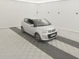 a small white car parked in a room with a black and white checkered floor