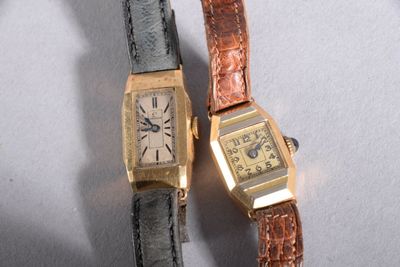 two watches sitting next to each other on a table