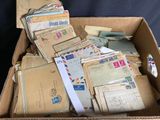 a cardboard box full of old letters and envelopes