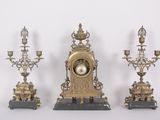 three different types of clocks on display on a table