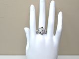a white mannequin hand with a ring on it