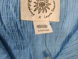 a close up of a blue shirt with a label on it