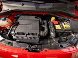 a red car with its hood open and the engine in the trunk