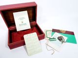 a red box with a watch and a note inside of it