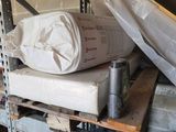 a pile of items sitting on a shelf in a garage