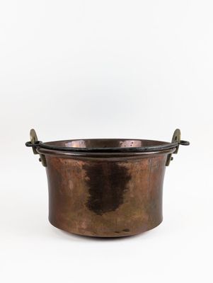an old copper pot with a handle on a white background