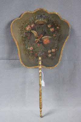 an antique fan with a bird and flowers design on it