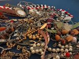a pile of assorted jewelry on a blue table