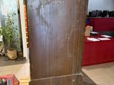 a refrigerator that is sitting on a pallet in the middle of a room