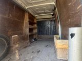 a van that is parked inside of a building with its door open