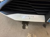 a close up of a car ' s grille with a sticker on it
