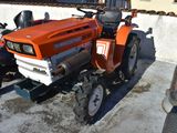 an orange tractor parked next to a red truck