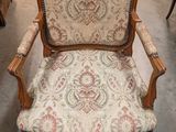 a chair with a floral upholstered seat in a store