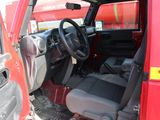a red truck with a black seat and steering wheel